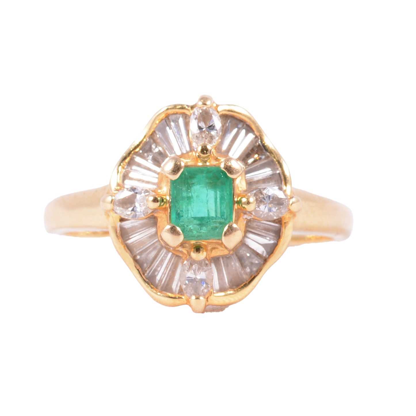 Lot 2 - An emerald and diamond cluster ring.