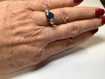 Lot 1 - A sapphire and diamond three stone ring.