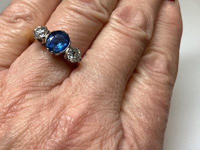 Lot 1 - A sapphire and diamond three stone ring.
