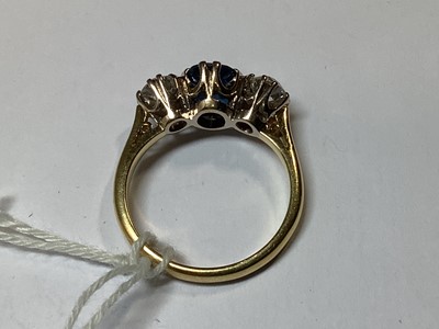 Lot 1 - A sapphire and diamond three stone ring.