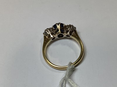 Lot 1 - A sapphire and diamond three stone ring.