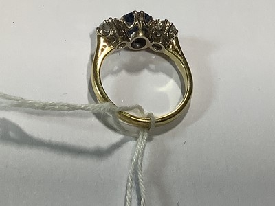 Lot 1 - A sapphire and diamond three stone ring.