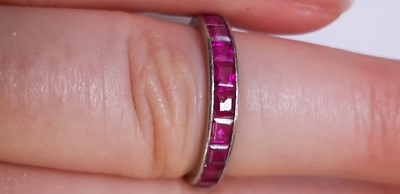 Lot 41 - A ruby full eternity ring.