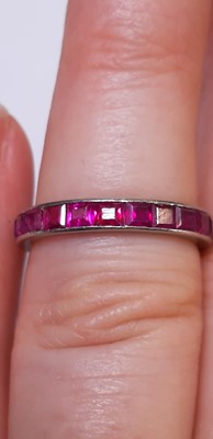 Lot 41 - A ruby full eternity ring.