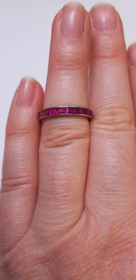 Lot 41 - A ruby full eternity ring.