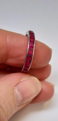 Lot 41 - A ruby full eternity ring.
