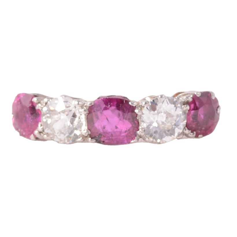 Lot 38 - A ruby and diamond half hoop ring.