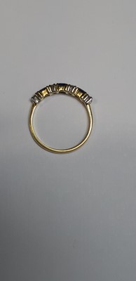 Lot 15 - A sapphire and diamond half eternity ring.