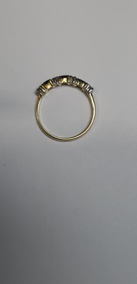 Lot 15 - A sapphire and diamond half eternity ring.