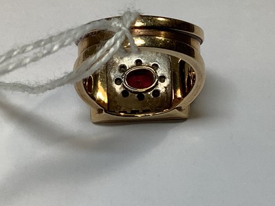 Lot 33 - A ruby and diamond square cluster ring on a heavy band.