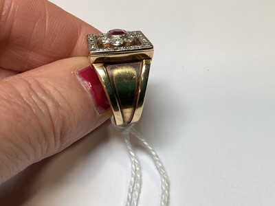 Lot 33 - A ruby and diamond square cluster ring on a heavy band.