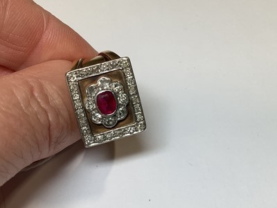 Lot 33 - A ruby and diamond square cluster ring on a heavy band.