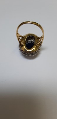 Lot 6 - A large sapphire and diamond cluster ring.