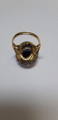 Lot 6 - A large sapphire and diamond cluster ring.