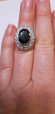 Lot 6 - A large sapphire and diamond cluster ring.