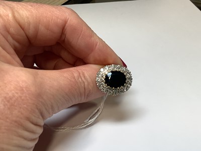 Lot 6 - A large sapphire and diamond cluster ring.
