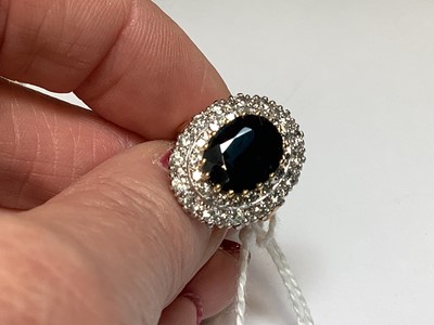 Lot 6 - A large sapphire and diamond cluster ring.
