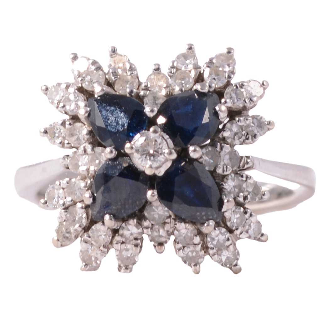 Lot 7 - A sapphire and diamond floral cluster ring.