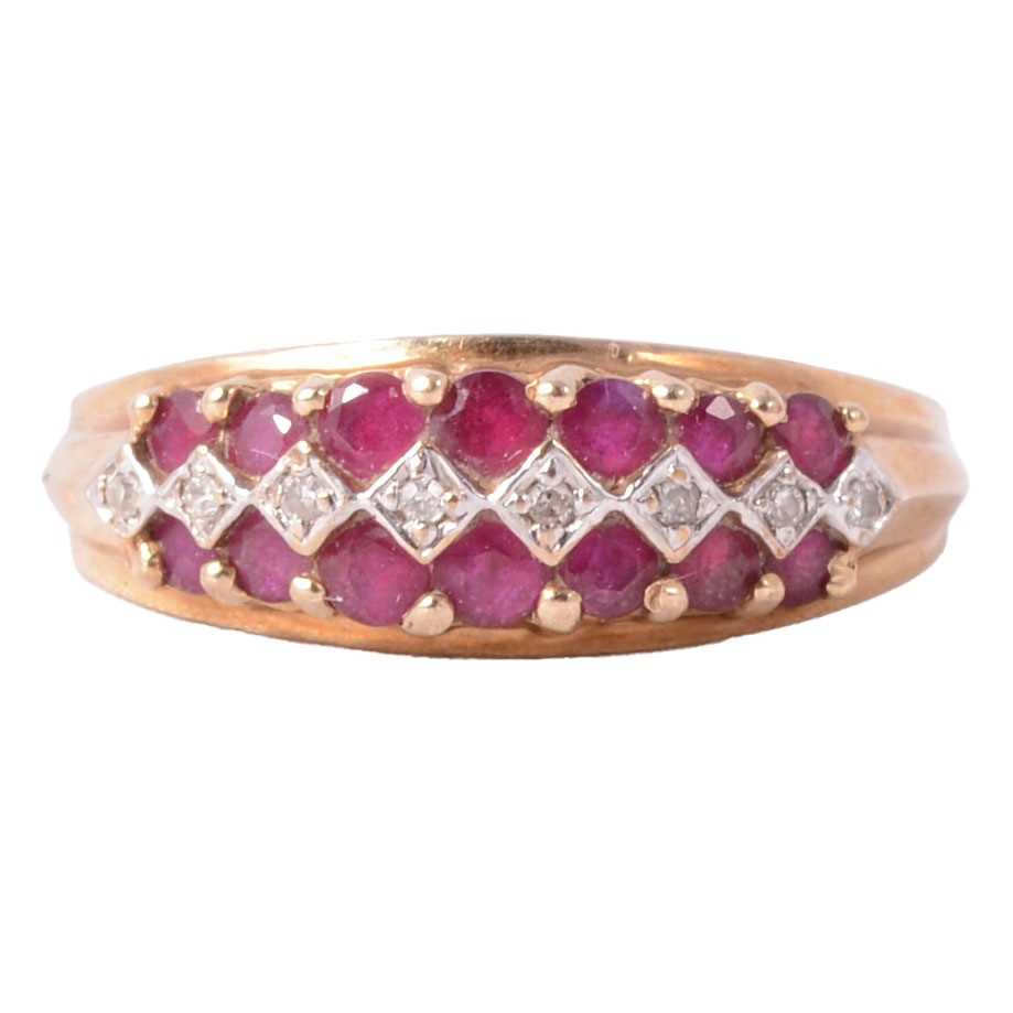 Lot 36 - A ruby and diamond half hoop ring.