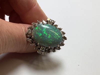 Lot 48 - A large black opal and diamond cluster ring.
