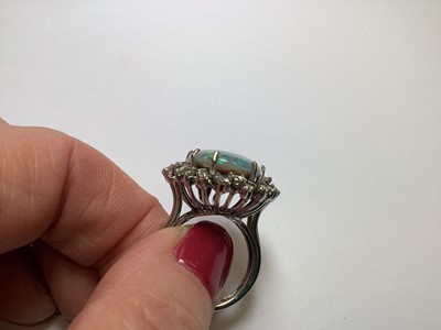 Lot 48 - A large black opal and diamond cluster ring.