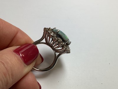 Lot 48 - A large black opal and diamond cluster ring.