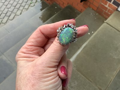 Lot 48 - A large black opal and diamond cluster ring.