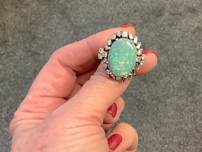 Lot 48 - A large black opal and diamond cluster ring.