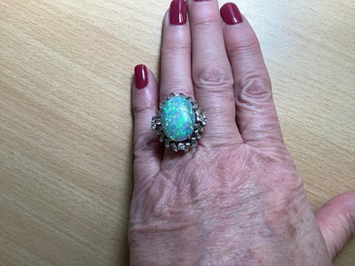 Lot 48 - A large black opal and diamond cluster ring.