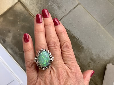 Lot 48 - A large black opal and diamond cluster ring.
