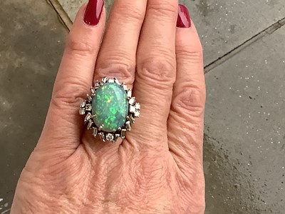Lot 48 - A large black opal and diamond cluster ring.