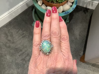 Lot 48 - A large black opal and diamond cluster ring.