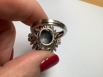 Lot 48 - A large black opal and diamond cluster ring.