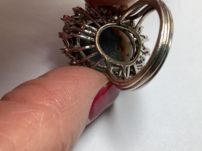 Lot 48 - A large black opal and diamond cluster ring.