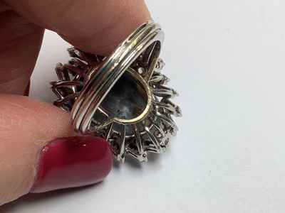 Lot 48 - A large black opal and diamond cluster ring.