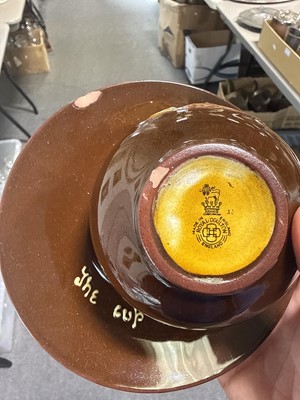 Lot 40 - Royal Doulton, a Kingsware 'The Cup that Cheers' tea-for-two