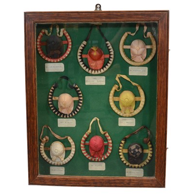 Lot 171 - Horse racing interest: a glazed display cabinet with horseshoes and jockey caps in silks