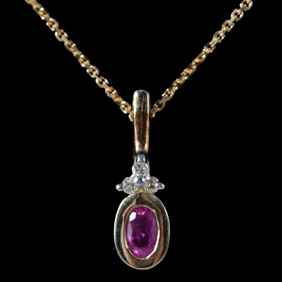 Lot 324 - A ruby and diamond pendant on a chain, with matching earrings.