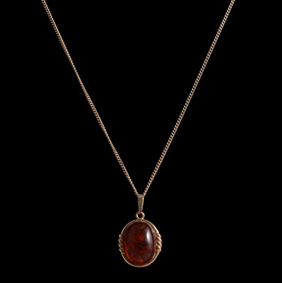 Lot 338 - An amber pendant and chain, earrings and ring.