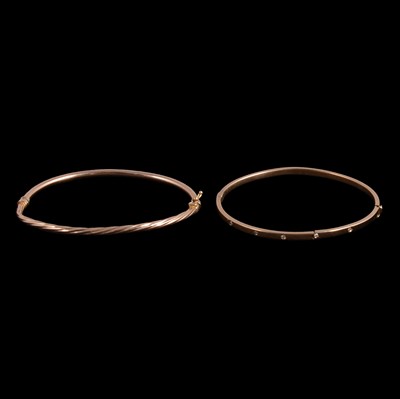 Lot 384 - Two gold / yellow metal broken bangles.