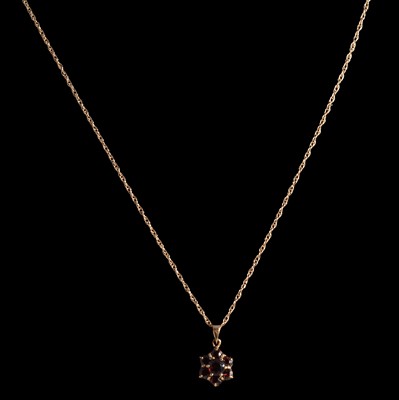 Lot 336 - Two garnet pendants on gold / yellow metal chains.