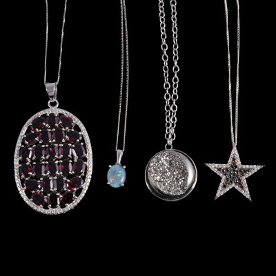 Lot 493 - Twenty silver pendants on chains, some gemset.