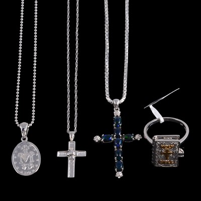 Lot 496 - A collection of gold, silver, and white metal religious pendants, some on chains, and a ring.
