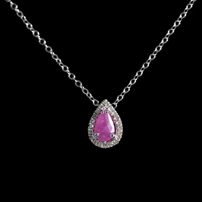 Lot 326 - A ruby and diamond pendant.