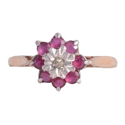 Lot 12 - A ruby and diamond reverse cluster ring.
