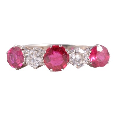 Lot 9 - A ruby and diamond half hoop ring.