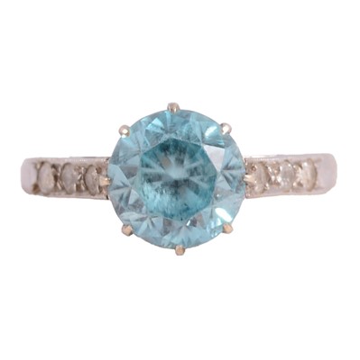 Lot 32 - A heat treated blue zircon and white stone (not diamond) ring.