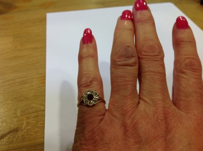 Lot 25 - A ruby and diamond cluster ring.