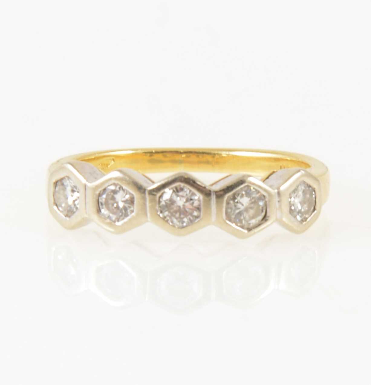 Lot 12 - A diamond five stone ring.