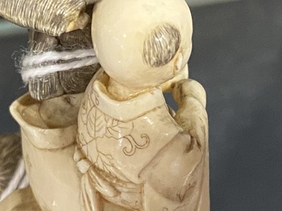 Lot 56 - A small Japanese carved and stained  ivory group, probably early 20th Century
